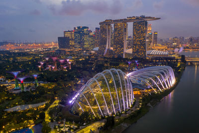 Illuminated buildings in city at dusk