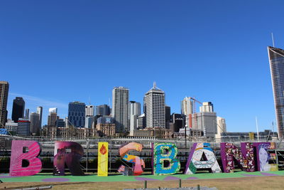 Low angle view of skyscrapers against clear blue sky