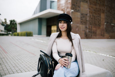 Portrait of young woman wearing hat