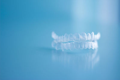 Close-up of plastic dentures against blue background