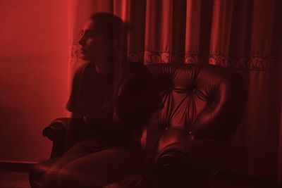 Woman sitting on sofa at home