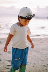 Rear view of boy standing on beach