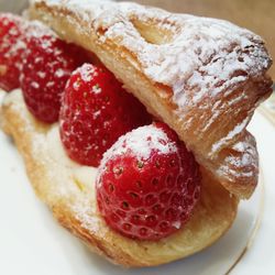 Close-up of strawberries in fresh bread with powdered sugar