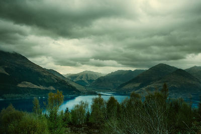 Scenic view of lake and mountains against sky