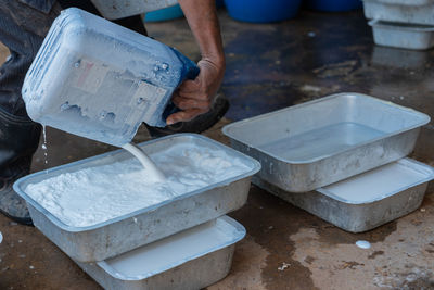 Low section of man working in container