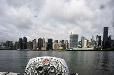 View of cityscape against cloudy sky