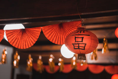 Low angle view of illuminated lanterns hanging from roof