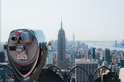 Observation binoculars with empire state building in the background