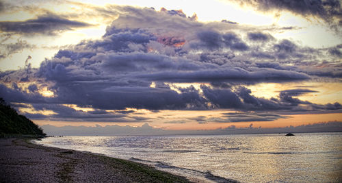 Scenic view of beach against sky during sunset