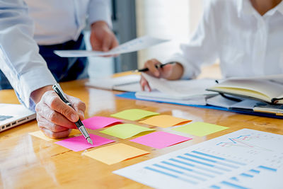 Cropped image of man working on table