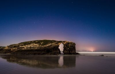 Scenic view of sea against clear sky at night