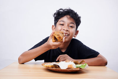 Portrait of young woman eating food