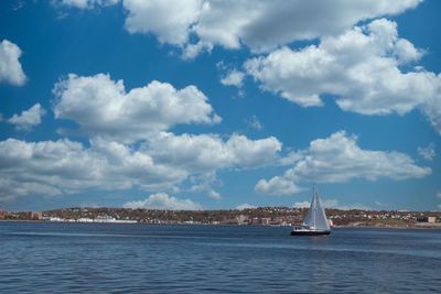 Sailboat sailing on sea against sky