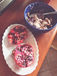 High angle view of pomegranate by ice cream on table