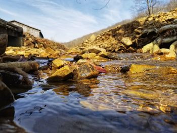 River amidst rocks against sky