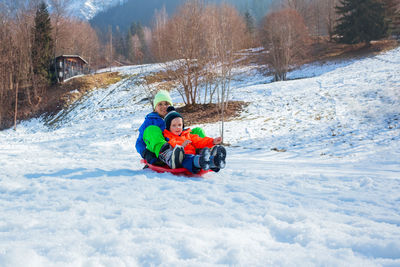 People skiing on snow covered field