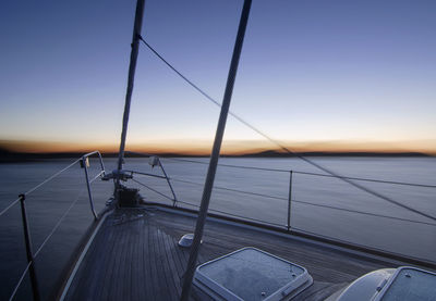 Boat sailing on sea against sky during sunset