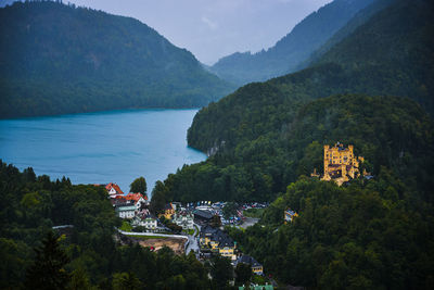 High angle view of townscape by sea against mountain