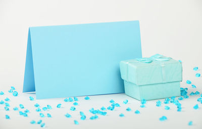 Low angle view of blue sky over white background