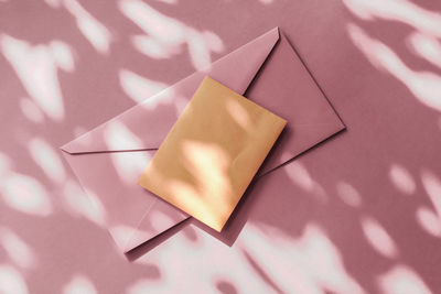 High angle view of hand holding gift box on table