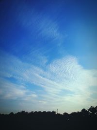 Scenic view of landscape against blue sky