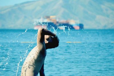 Close-up of man swimming in sea