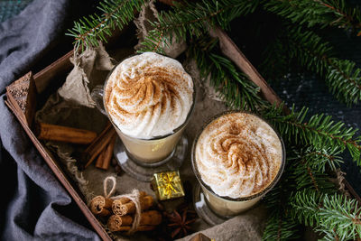 High angle view of drink by pine needle in tray