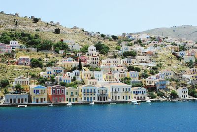 Town by sea against clear sky