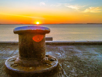 Close-up of sea against sky during sunset