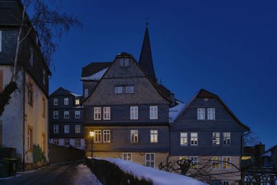 Low angle view of illuminated building against blue sky