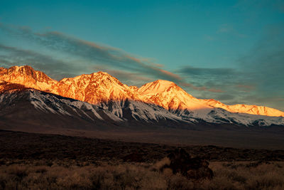 Scenic view of snowcapped mountains against sky during sunset