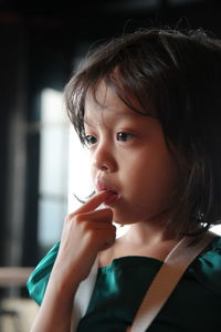 Close-up of cute girl looking away