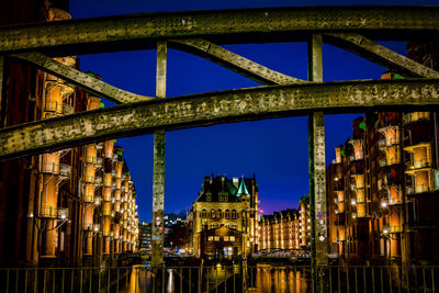 Illuminated building against sky