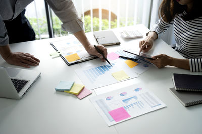 People working on table in office