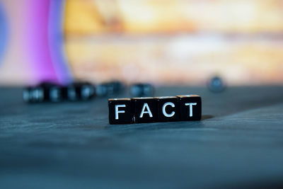 Close-up of information sign on table