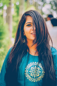 Portrait of smiling beautiful woman standing outdoors