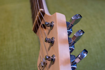 Close-up of playing guitar on wood