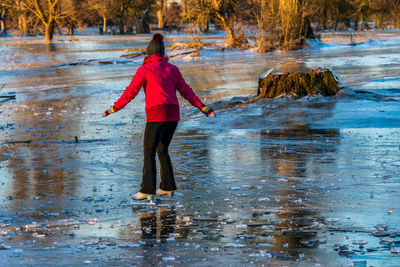 Rear view of woman in lake