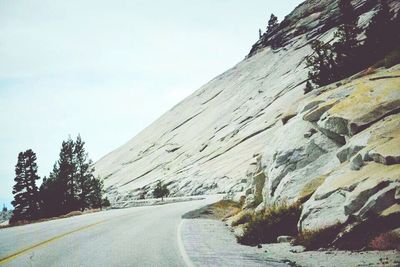 Empty road leading towards mountains
