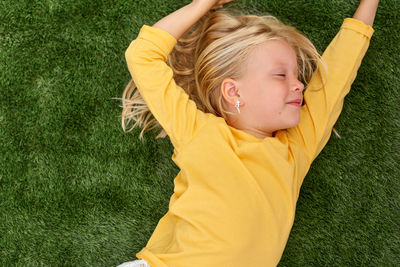 Portrait of young woman exercising on field