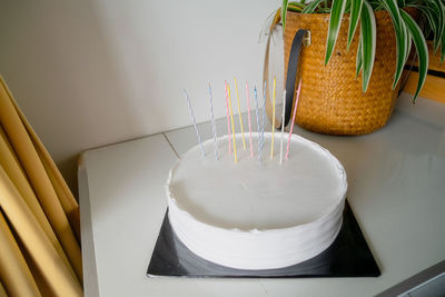 White cake with candles and blank background space on black cake board and birthday cake mockup