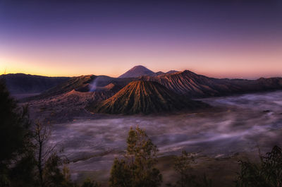 Panoramic view of volcanic landscape against sky during sunset