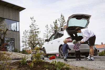 Man vacuuming car boot