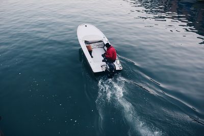 High angle view of man sailing motorboat on lake