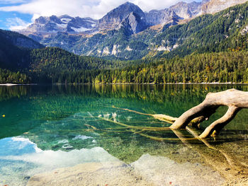 Scenic view of lake by mountains against sky