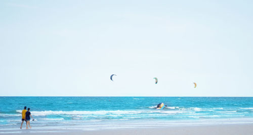 People on beach against sky