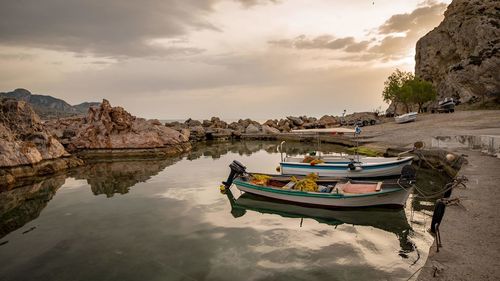 Boat moored on beach against sky