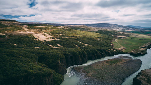 Scenic view of river amidst mountains against sky