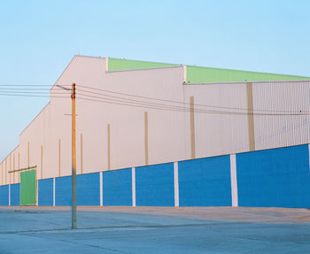 Built structure on beach against clear blue sky
