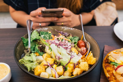 Close-up of man having food on table